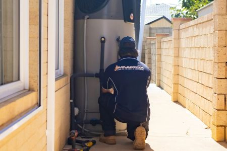 Plumber repairing a hot water system after a loss of hot water.