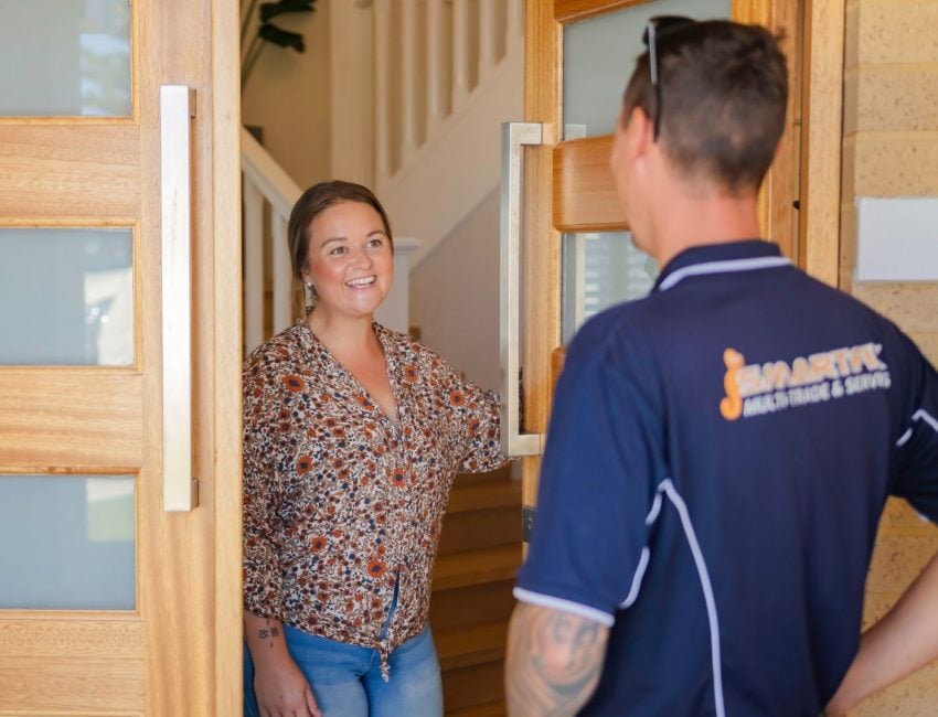 Smartfix tradie greeting customer at front door