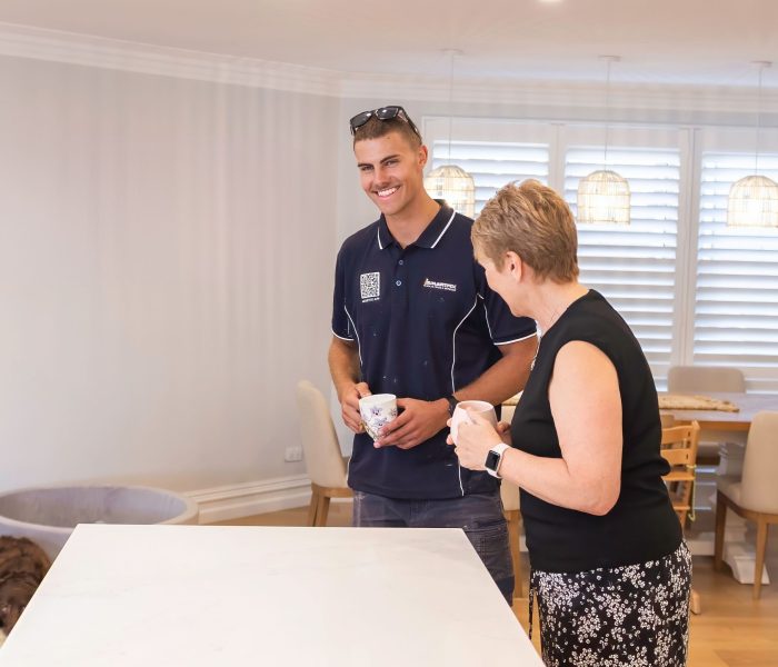 Smartfix painter with customer in newly painted home