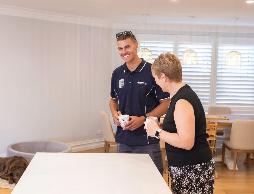 Smartfix painter with customer in newly painted home