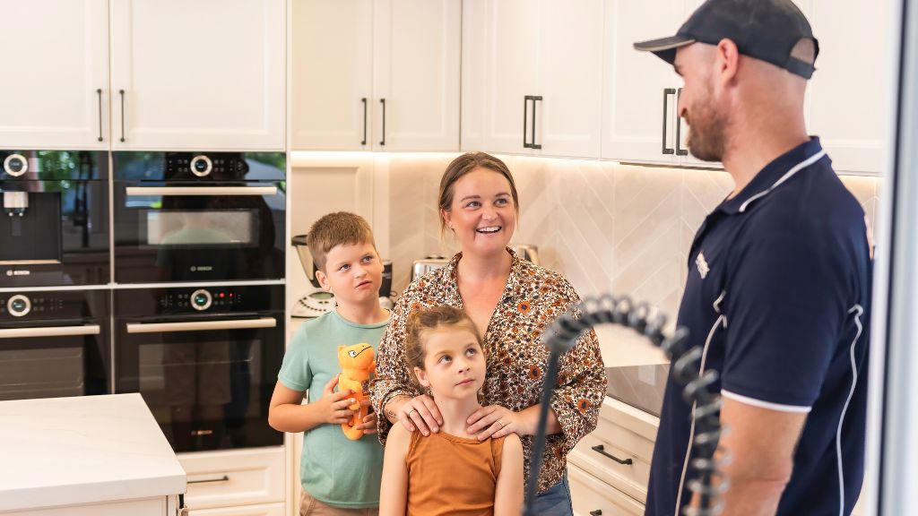 Smartfix plumbing finished installing kitchen tap and is now talking with customer