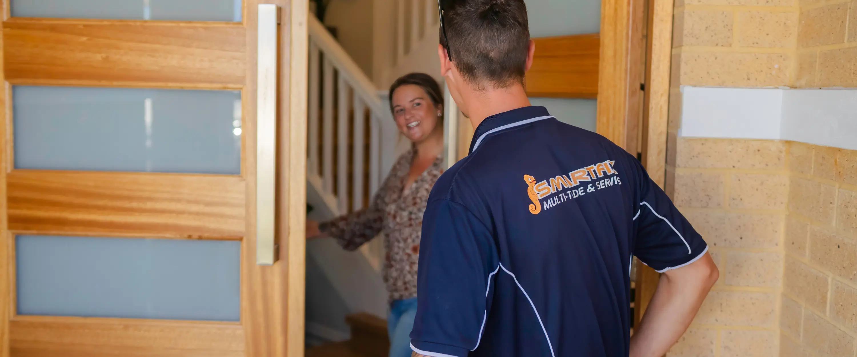 Smartfix tradie arriving at a Perth home to provide multi-trade services, greeted by a smiling customer at the front door.